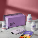 A product bundle display for GleeFull Supplements on a marble surface against a red background. The layout includes a large purple shipping box featuring the slogan 'FEEL LIKE YOURSELF AGAIN.', three white bottles of GLP-1 Crave Control, a purple branded pen, a matching notepad that reads 'REMINDERS WHEN I'M HAVING A MENOPAUSE MOMENT', and a recipe booklet titled 'THE MENOPAUSE Recipes'
