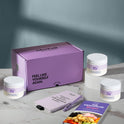A product bundle display for GleeFull Supplements on a marble surface against a blue background. The layout includes a large purple shipping box featuring the slogan 'FEEL LIKE YOURSELF AGAIN.', three white bottles of Flat Tummy Tea, a purple branded pen, a matching notepad that reads 'REMINDERS WHEN I'M HAVING A MENOPAUSE MOMENT', and a recipe booklet titled 'THE MENOPAUSE Recipes'