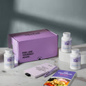 A product bundle display for GleeFull Supplements on a marble surface against a blue background. The layout includes a large purple shipping box featuring the slogan 'FEEL LIKE YOURSELF AGAIN.', three white bottles of Bloat Buster, a purple branded pen, a matching notepad that reads 'REMINDERS WHEN I'M HAVING A MENOPAUSE MOMENT', and a recipe booklet titled 'THE MENOPAUSE Recipes'
